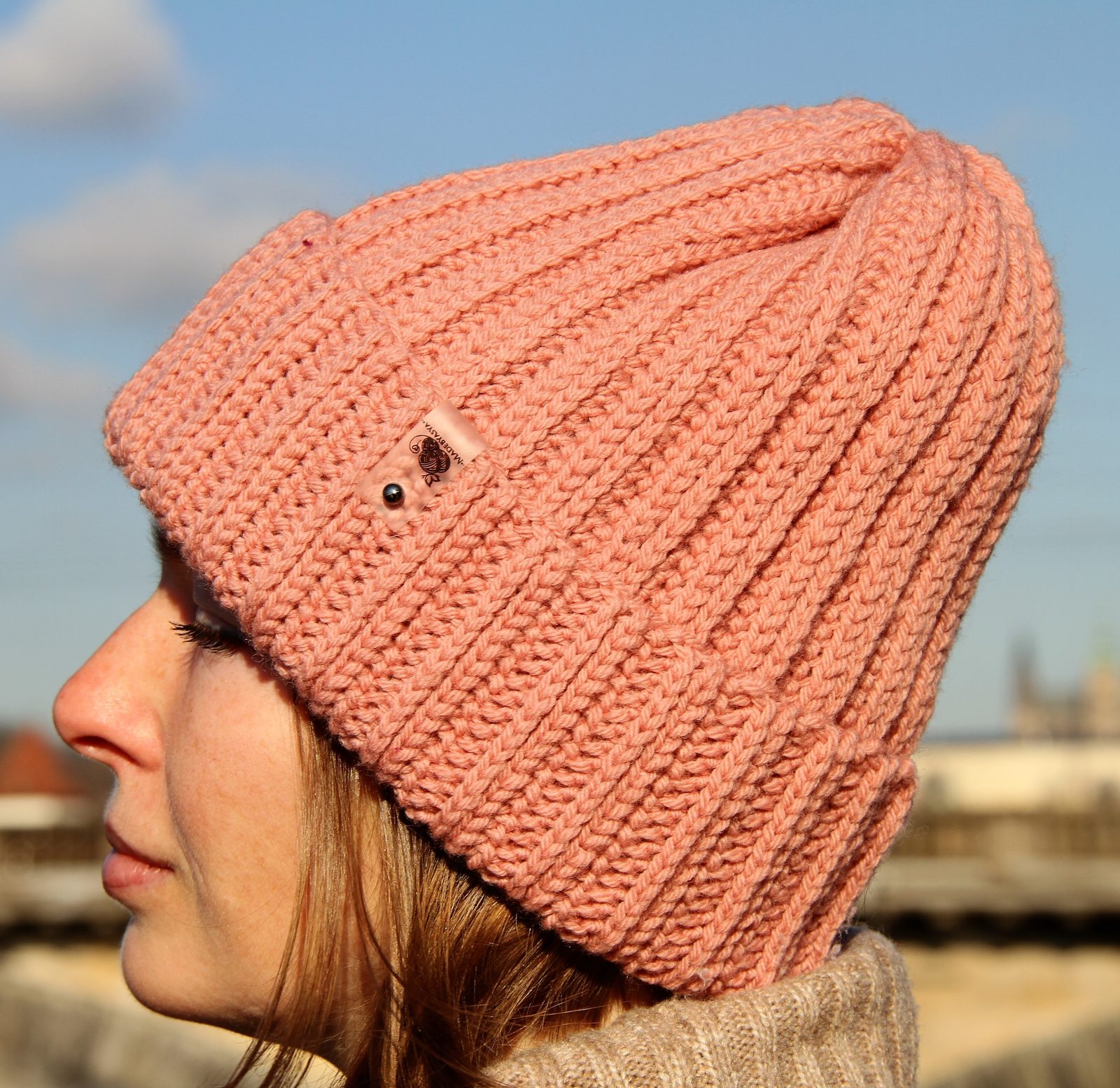 Marshmallow crochet beanie in dusty peach, side profile showing the puffy knit-look rib texture